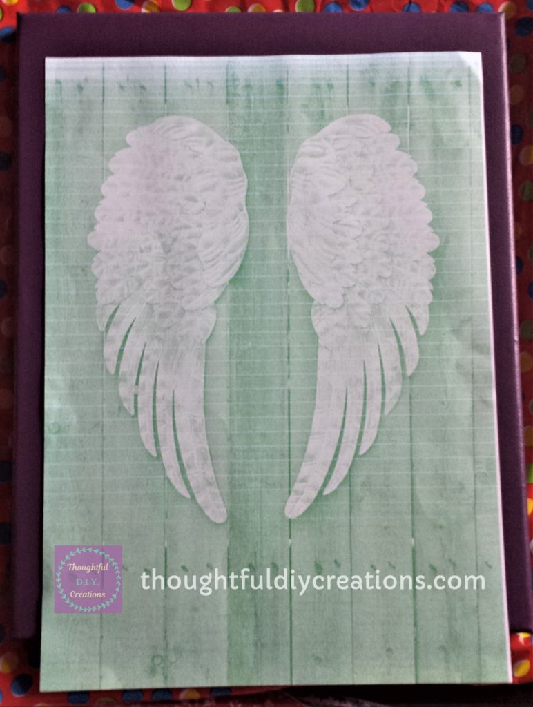 'Angel Wing Silhouette' print- out positioned on the canvas using glue dots.