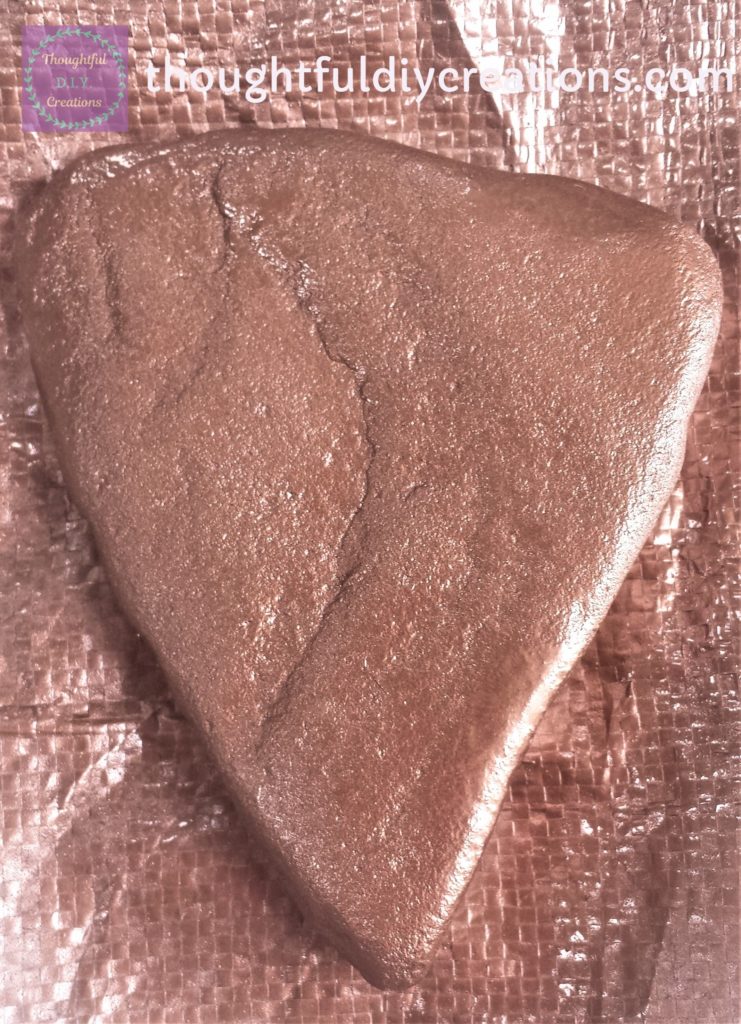 Wide Triangular Shaped Stone after being Spray Painted Copper.