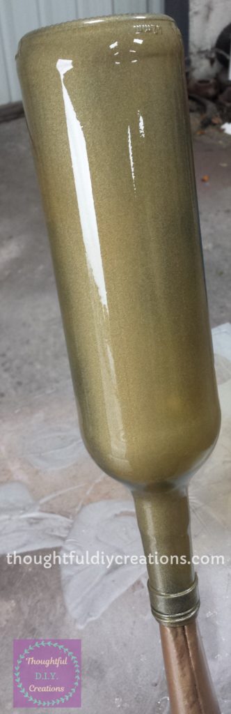 First Layer of Gold Spray Paint on the Wine Bottle.
