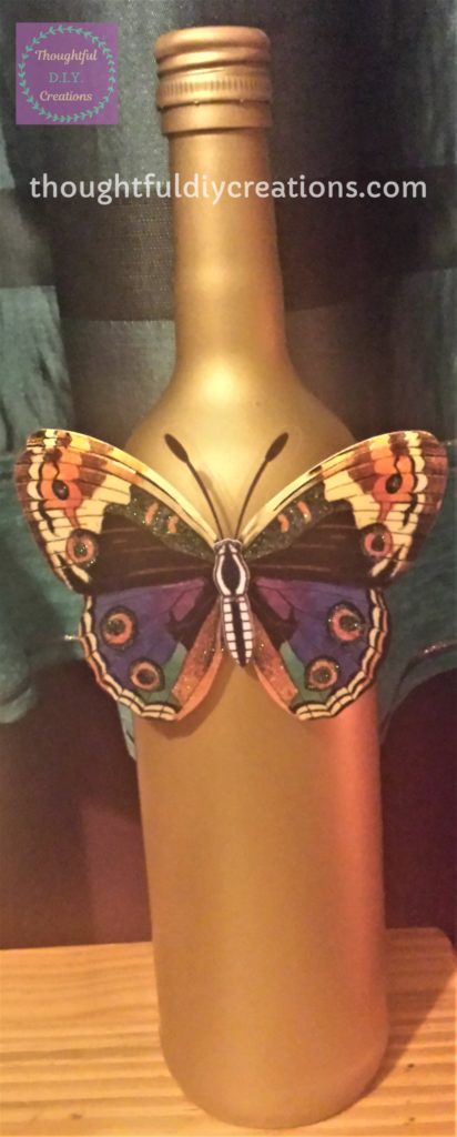 5-D Butterfly Sticker attached to the Gold Spray Painted Wine Bottle.