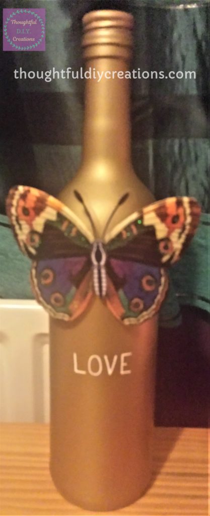 Starting to write the 'Love Quote' on the Gold Spray Painted Wine Bottle.