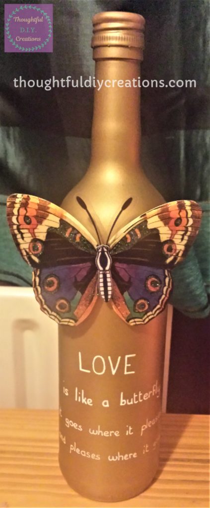 Full 'Love Quote' written on the Gold Spray Painted Wine Bottle using a white paint pen.