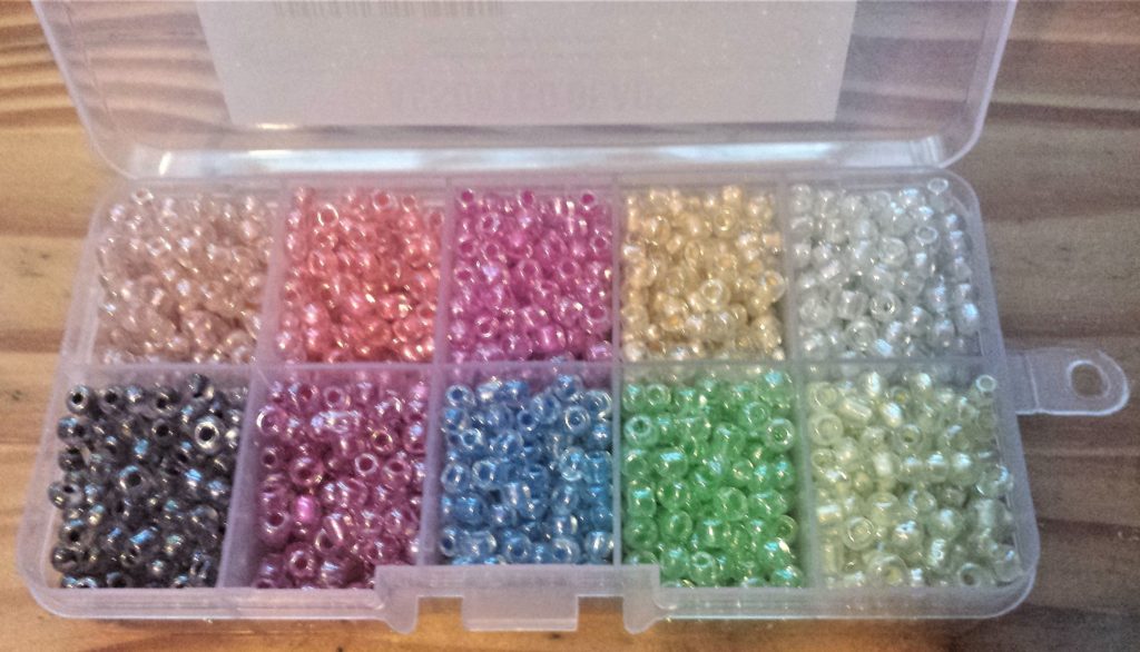 Inside of the box of 10 colour assortment of beads.