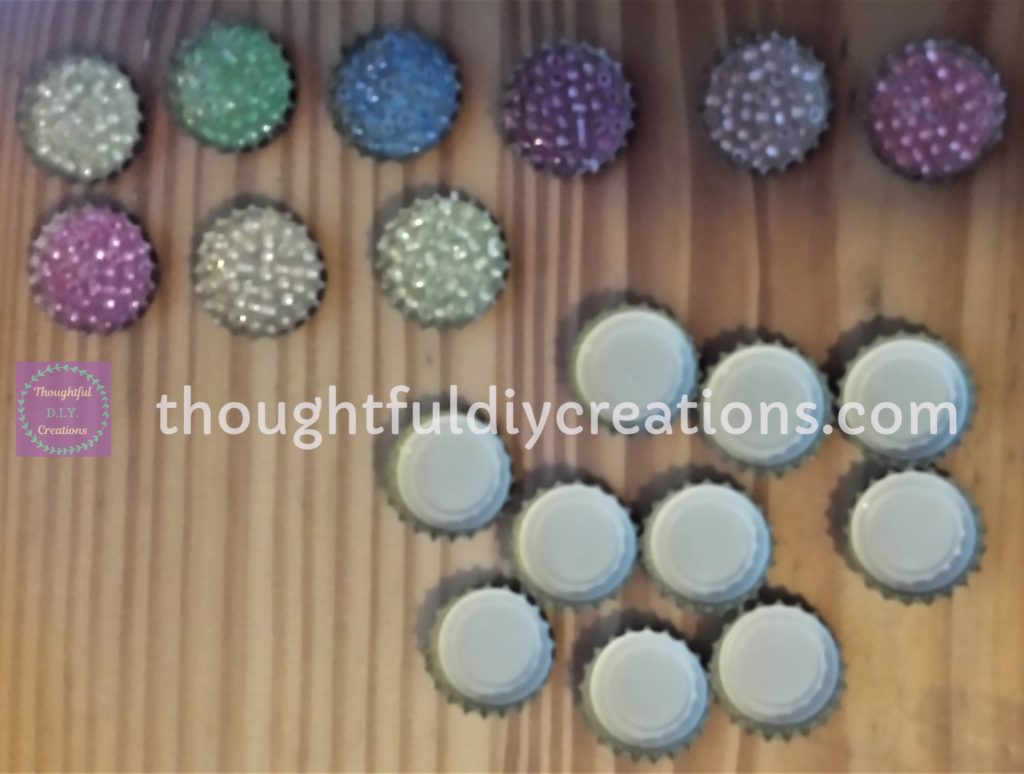 9 Beer Bottle Caps filled with beads and 10 Beer Bottle Caps ready to be filled with beads.