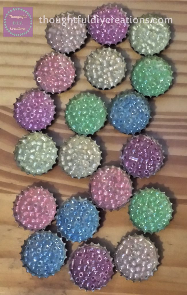 19 Beer Bottle Caps filled with beads.