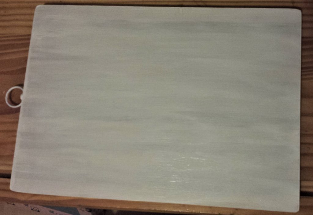 Second layer of gesso on the front of the chopping board.