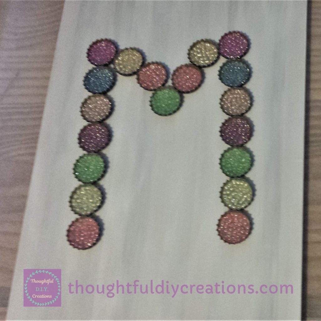 Planning the layout of the monogram on the chopping board.