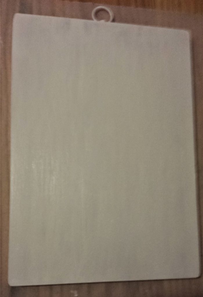 Third and final layer of white paint on the front of the chopping board.