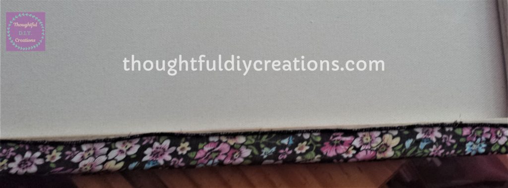 Floral Fabric glued to the first back and edge of the canvas.