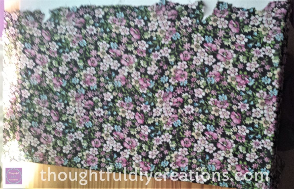 First part of Floral Fabric glued to the front of the canvas.