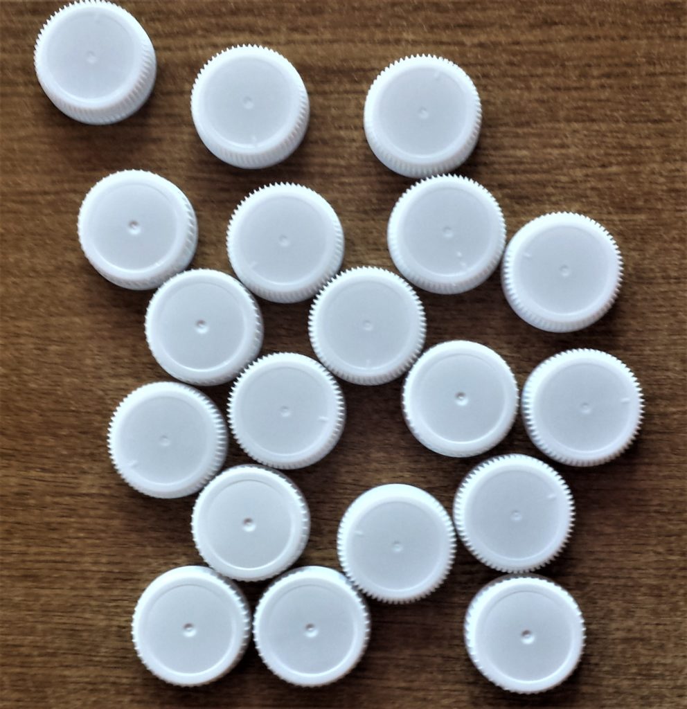 Milk carton lids after being washed and dried.
