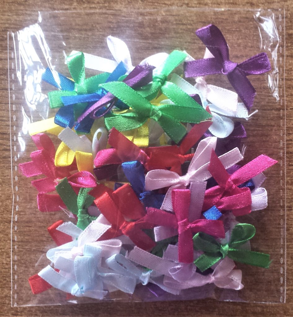 Packet of colourful mini bows.