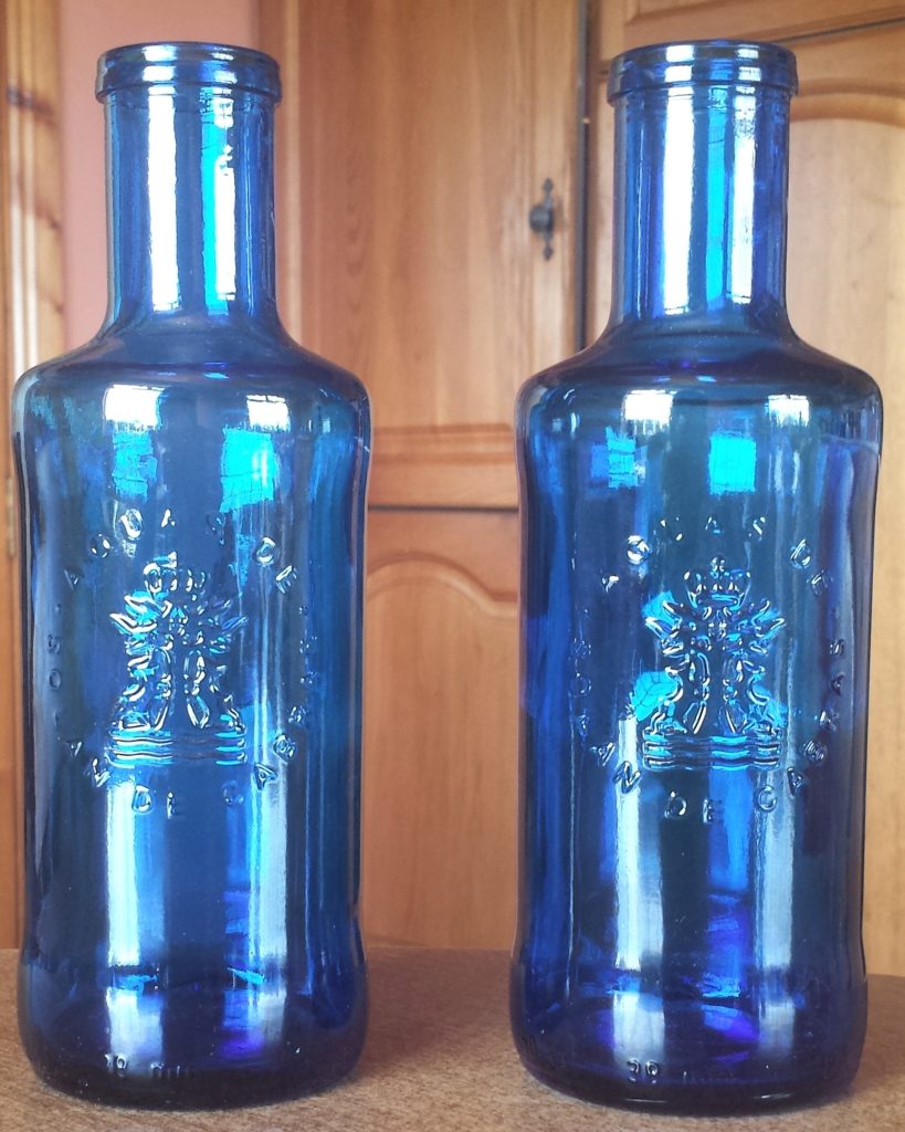 Two Blue Glass Water Bottles after being washed.