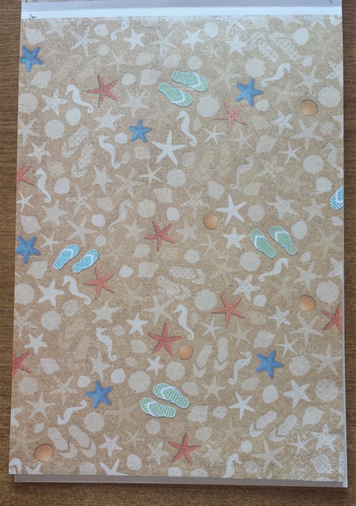 Close up image of one sheet of beach themed paper.