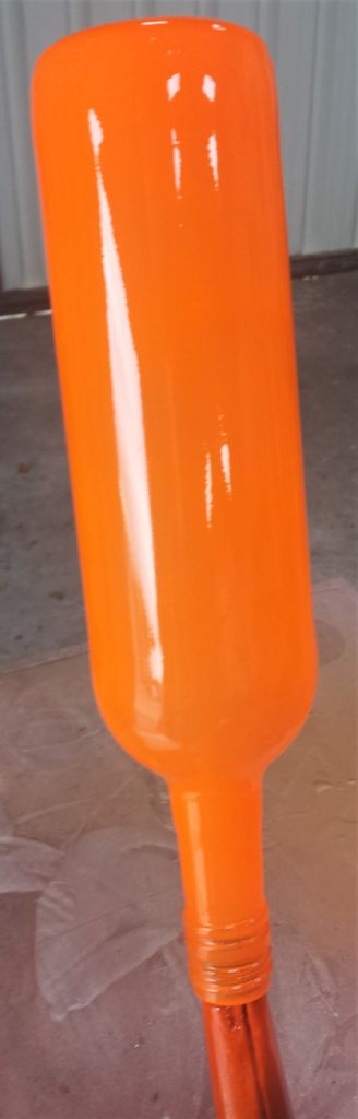 First layer of spray paint on the bottle.