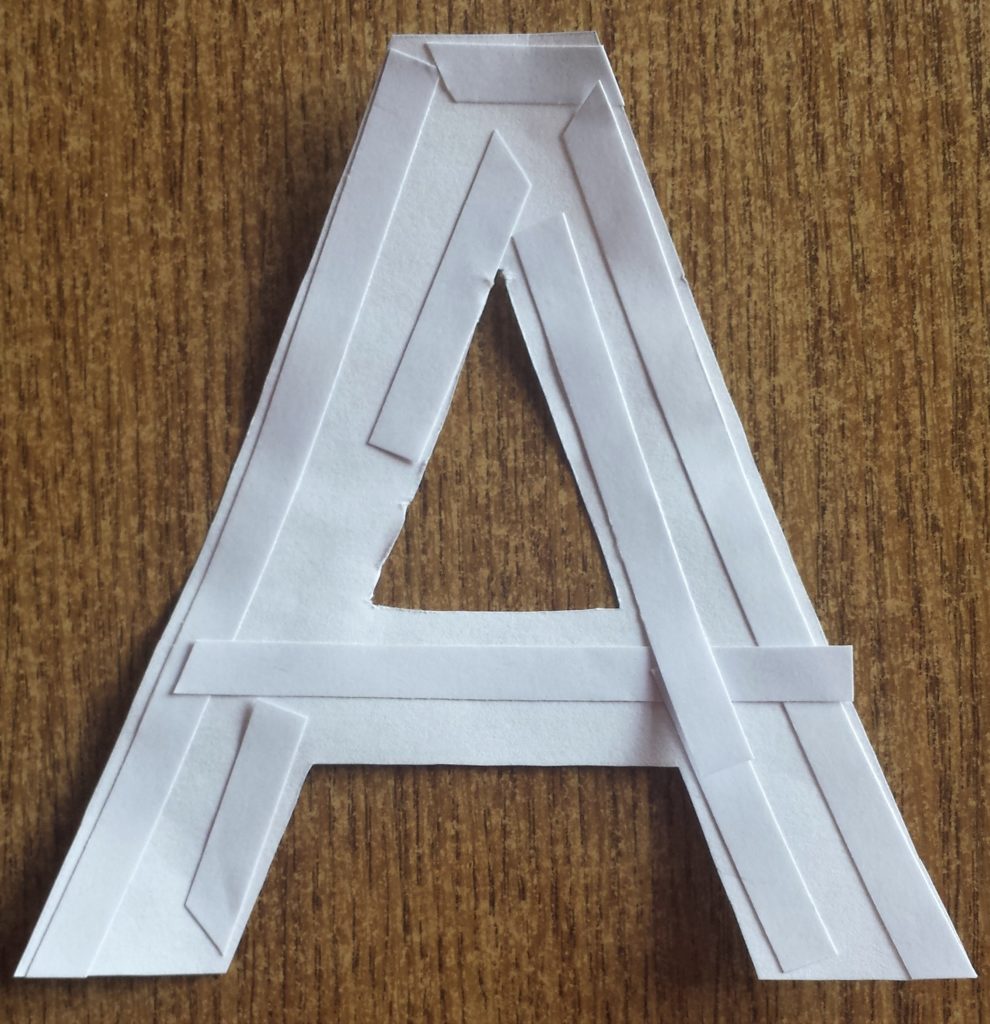 The letter 'A' with double sided tape on the back of it.