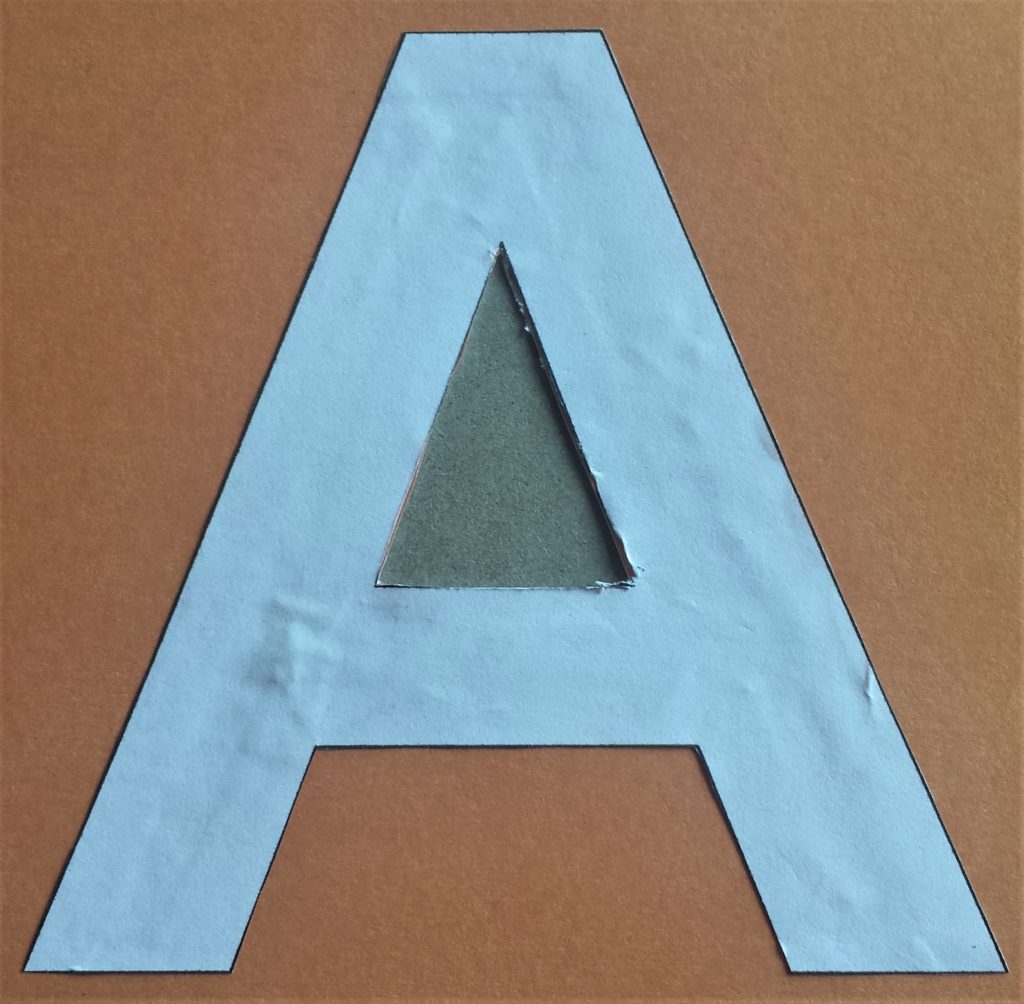 The letter 'A' with the mid-section cut out using a craft knife.