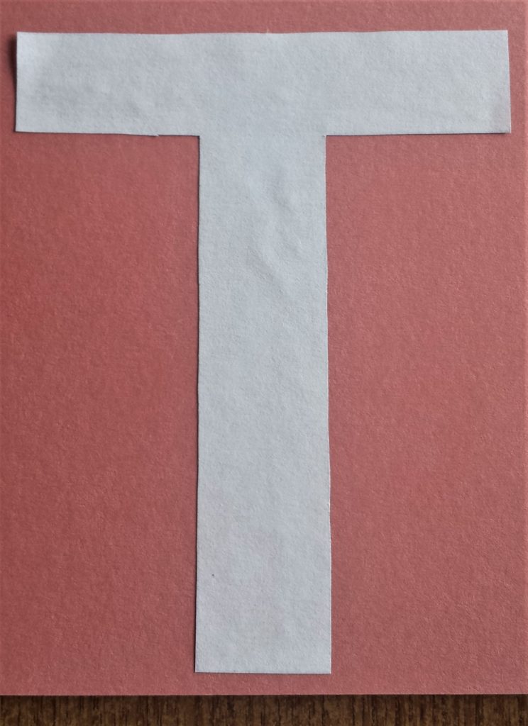 The letter 'T' glued to the back of the Autumn paper.