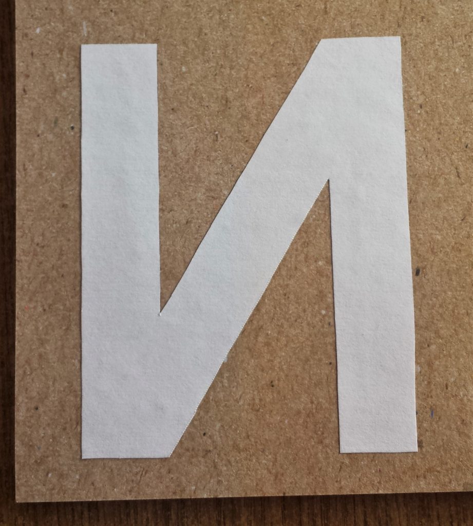 The letter 'N' glued to the back of the Autumn paper.