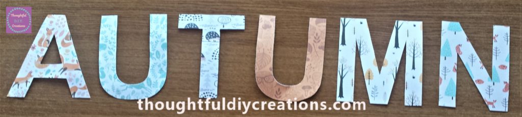 The letters spelling the word 'Autumn' all covered in Autumn style of papers.