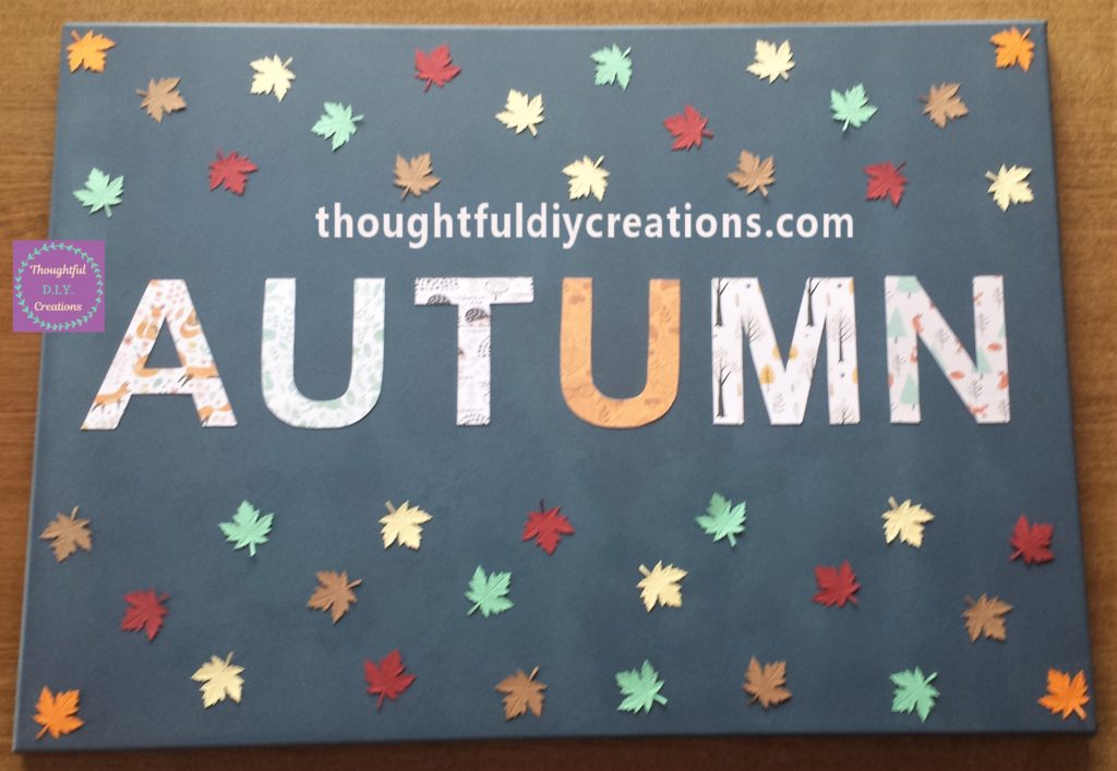 The leaves placed on the canvas before being glued down.