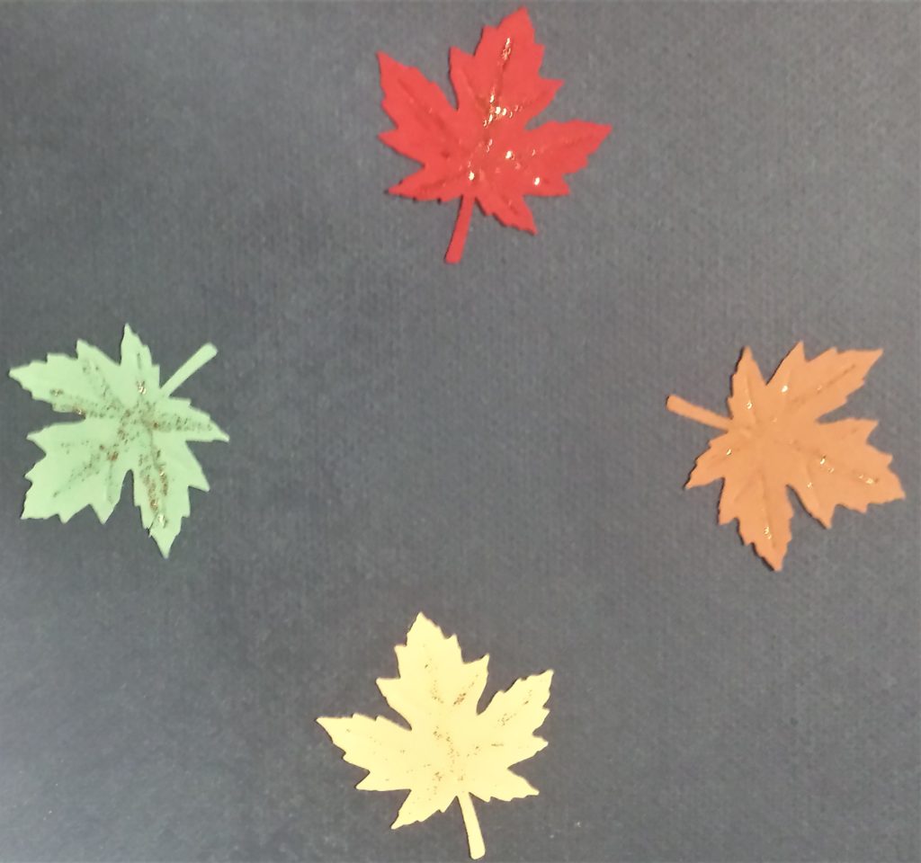 The leaves with gold glitter added to the imprinted lines.