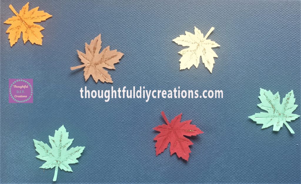 Close up image of the leaves with gold eye liner on the lines of the leaves.