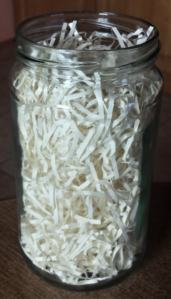 Jar filled with straw effect paper.