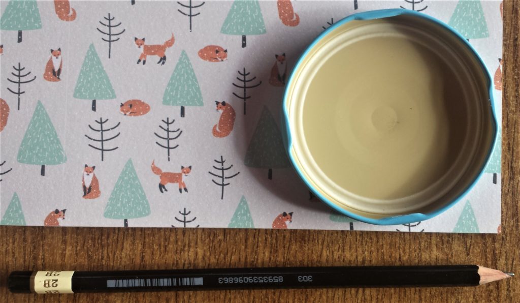 Lid on the paper and pencil.