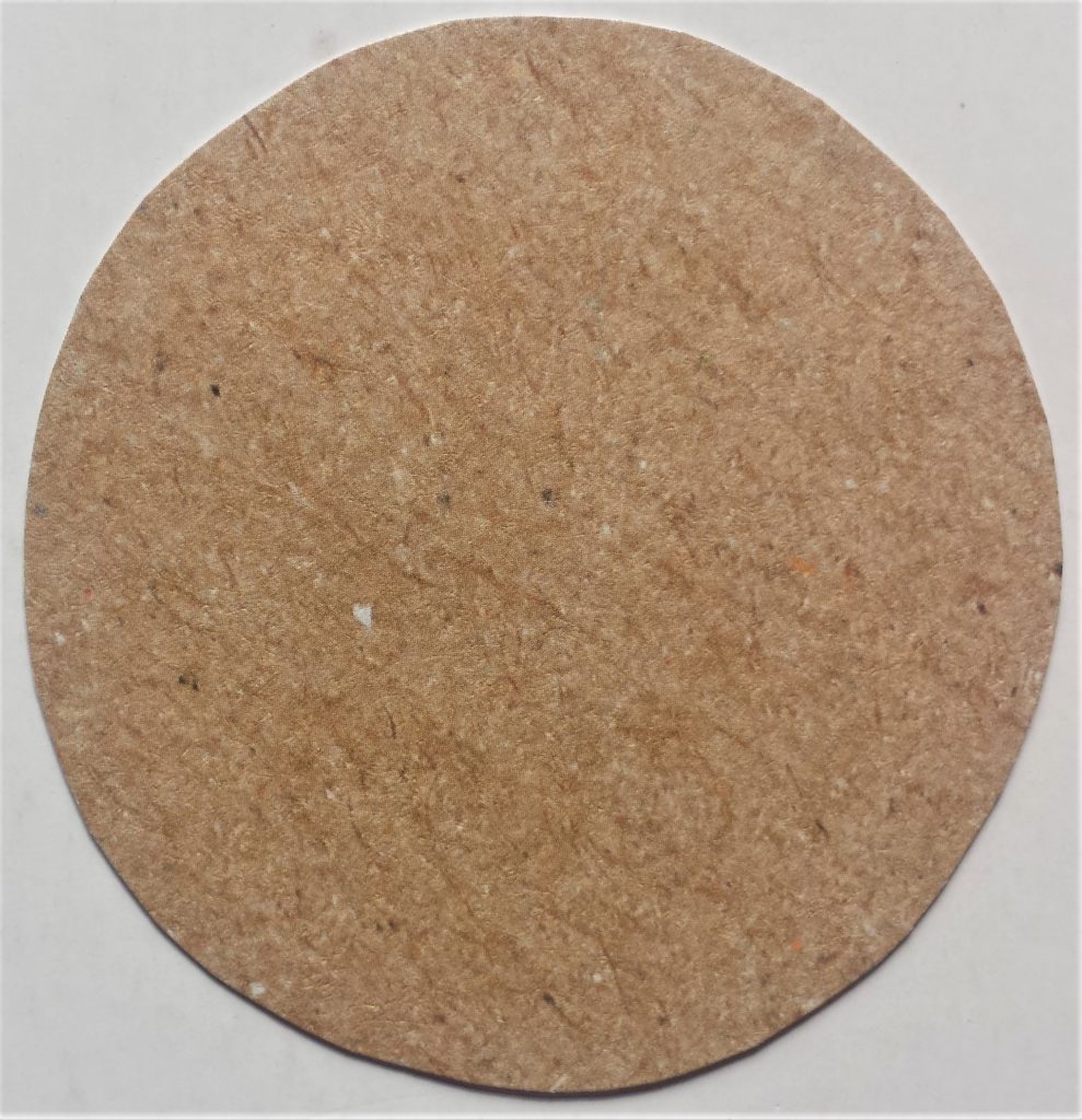 Circle of brown paper cut out for the lid of the jar.