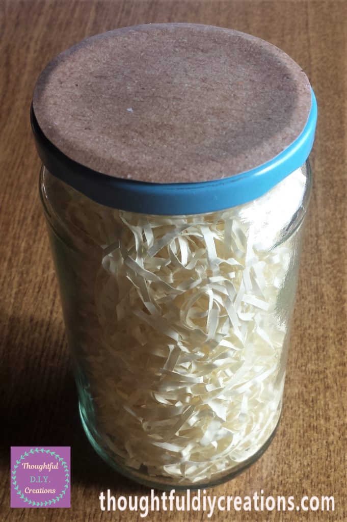 Brown paper circle glued onto the lid on the jar.