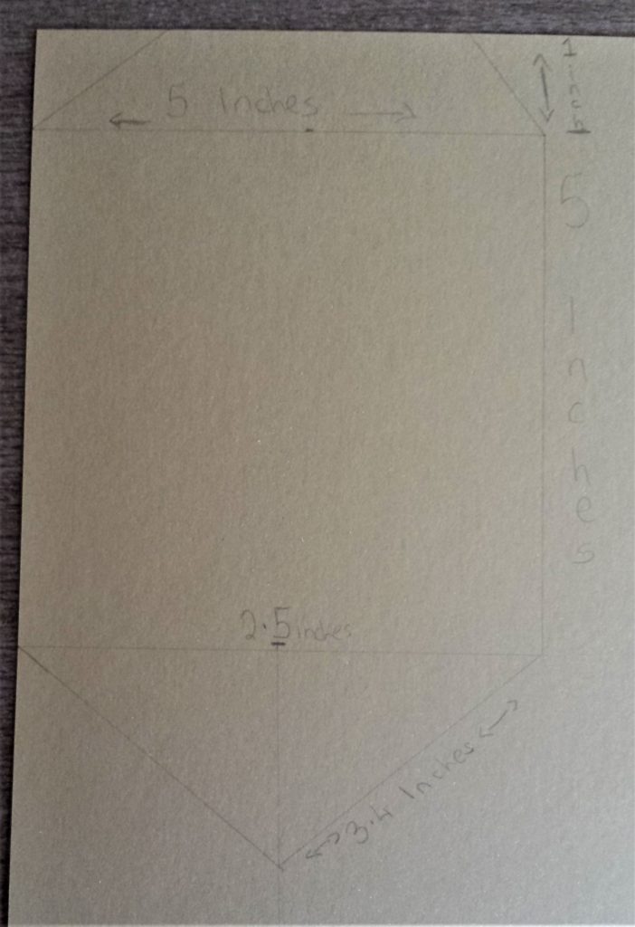 Drawing of the bunting shape with measurements wrote down on the card.