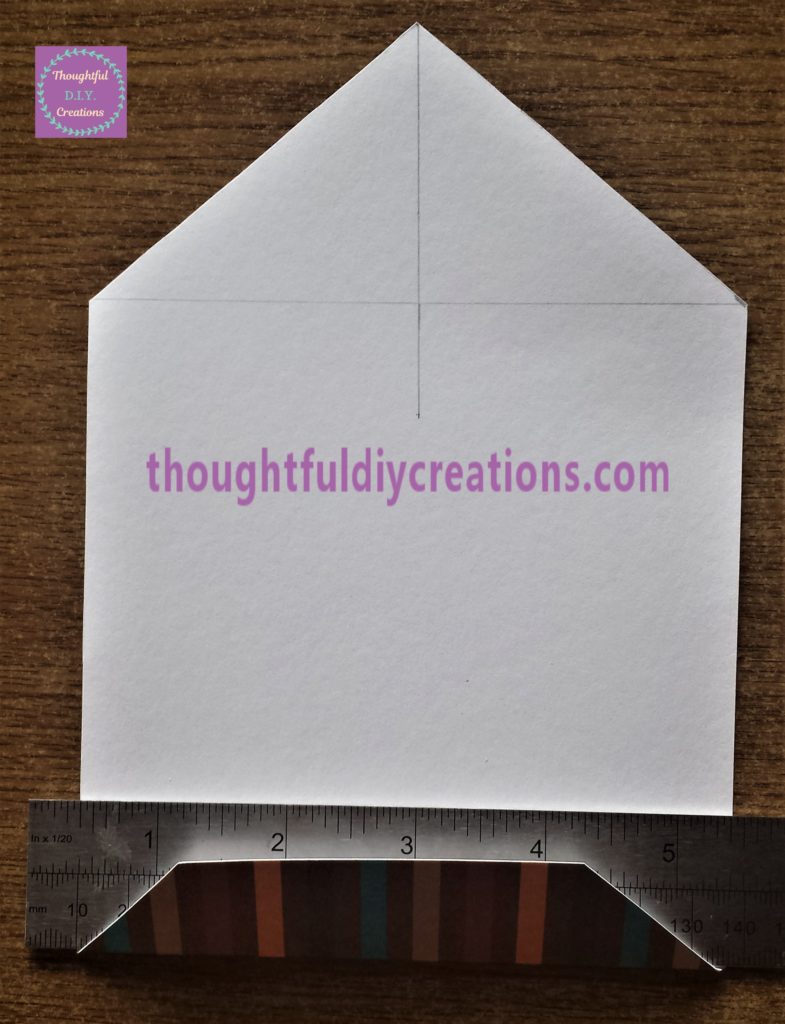 Folding over the top of the bunting to the back with the help of a ruler.