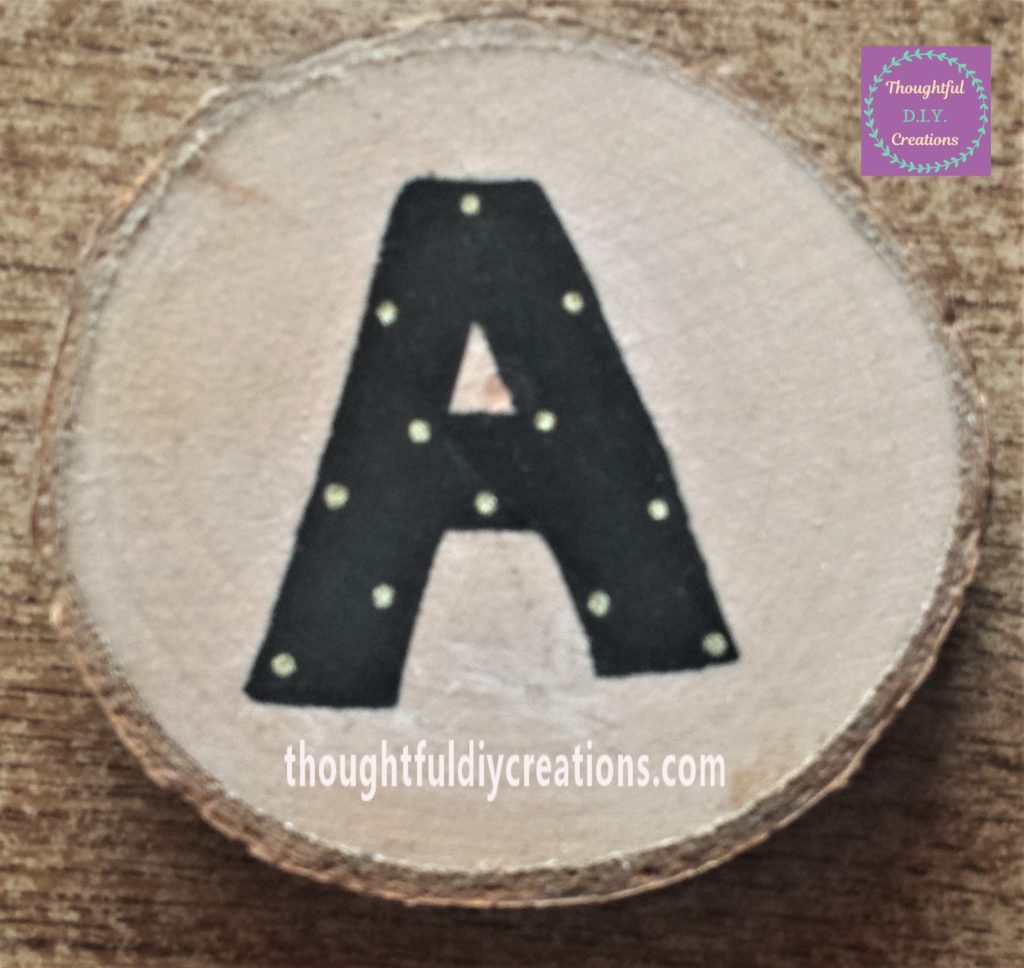 Gold dots added to the letter 'A' using a paint pen.