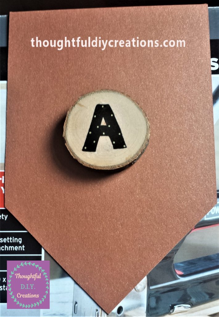 The branch offcut hot glued to the mid-section of the bunting.