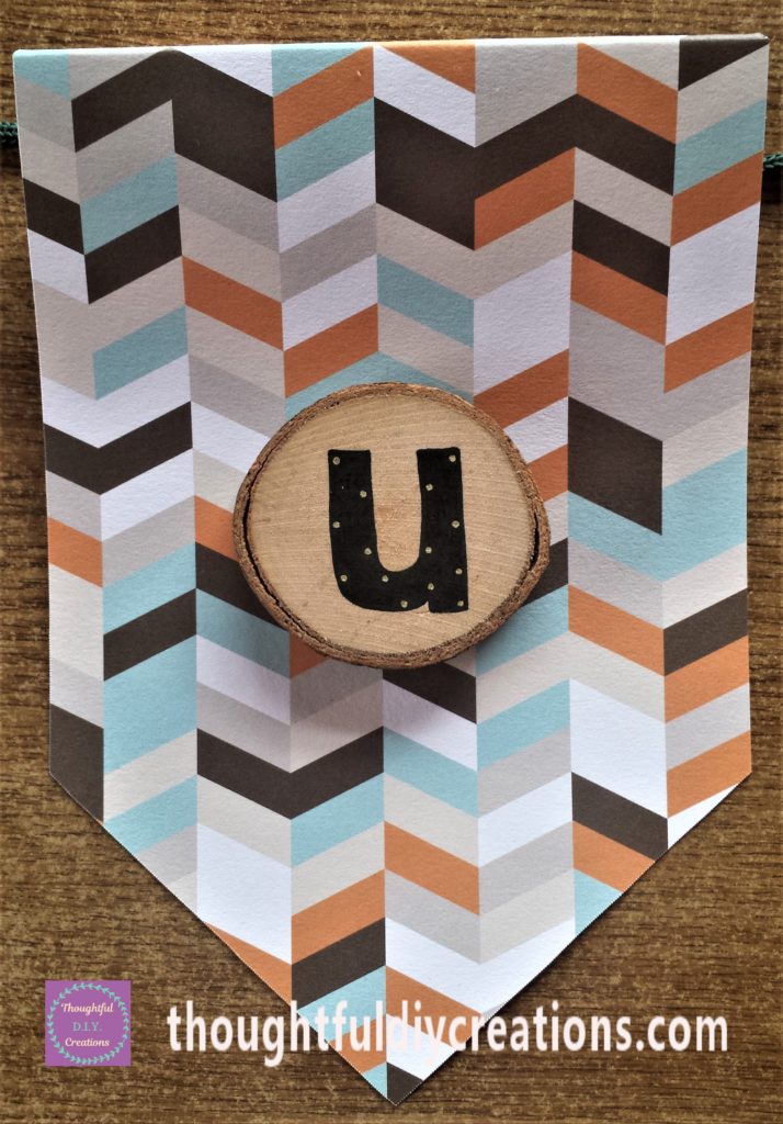 The letter 'U' hot glued to the bunting.
