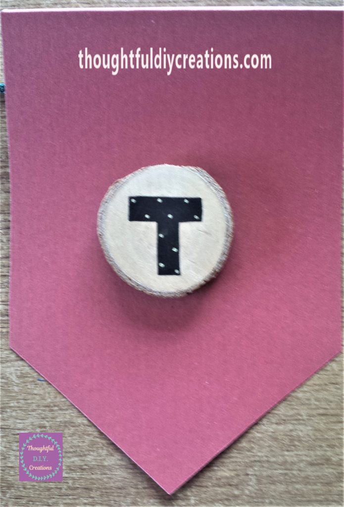 The letter 'T' hot glued to the bunting.