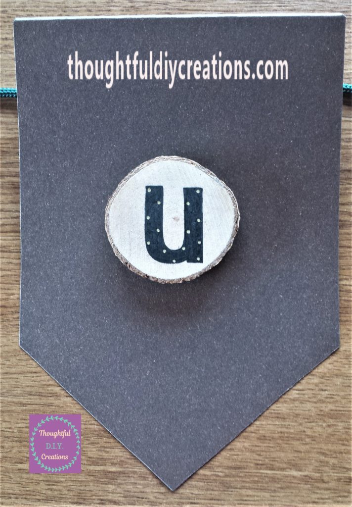 The second letter 'U' hot glued to the bunting.