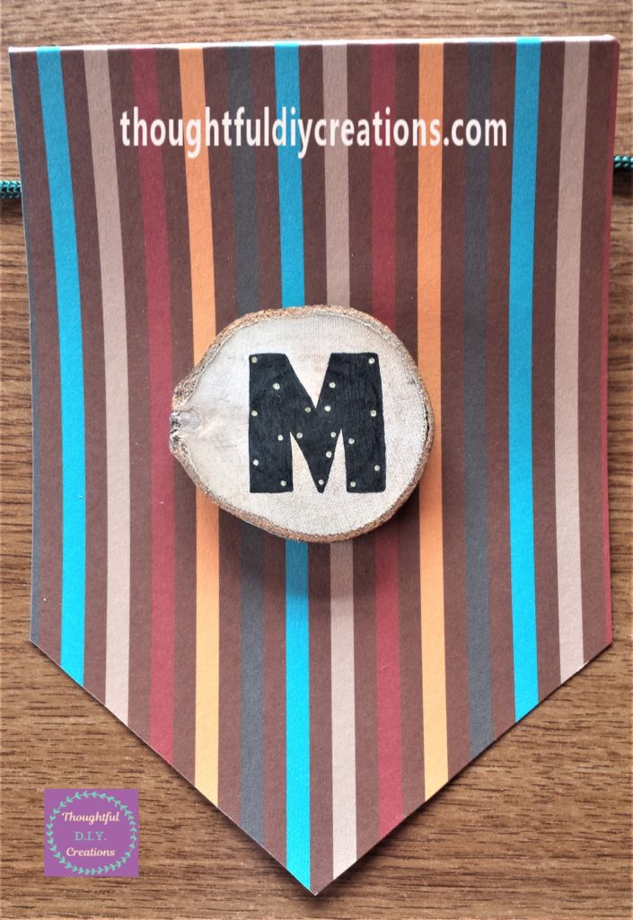 The letter 'M' hot glued to the bunting.