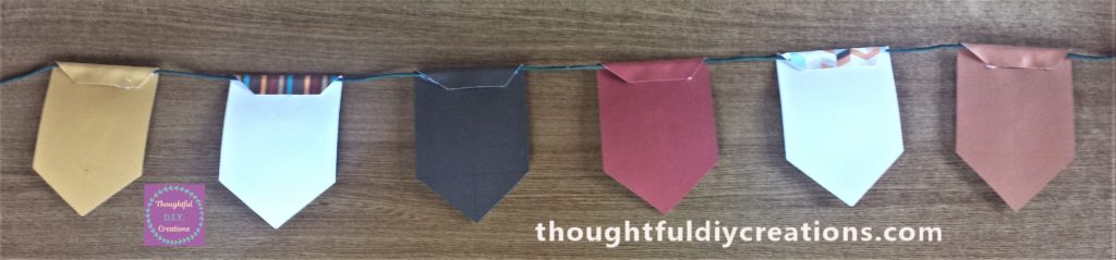 The string hot glued to each piece of the bunting.