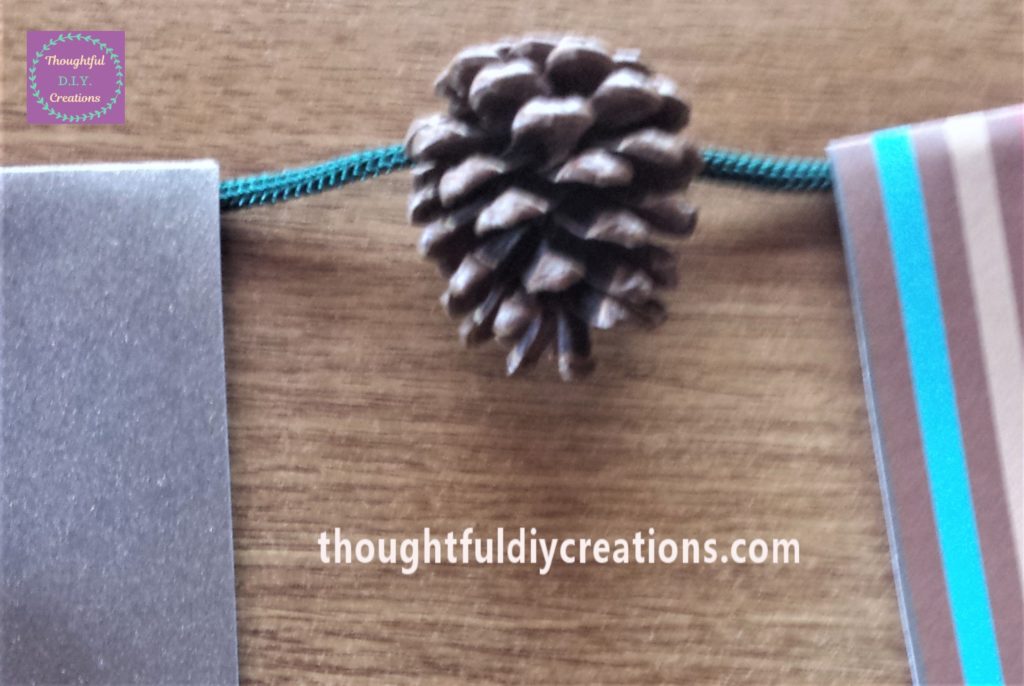 Pine cone glued to the string.
