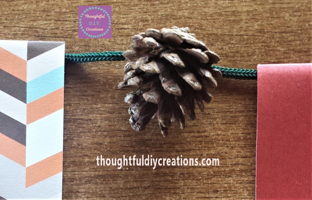 Pine cone glued to the string.