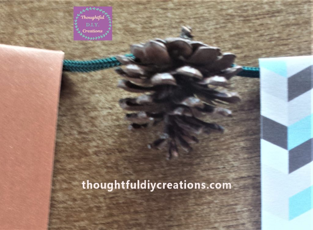 Pine cone glued to the string.