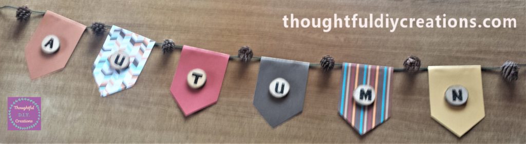 Front view of all the pine cones glued to the string.