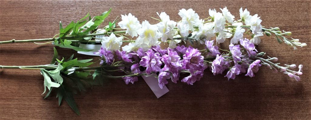 Cream and purple artificial flowers.