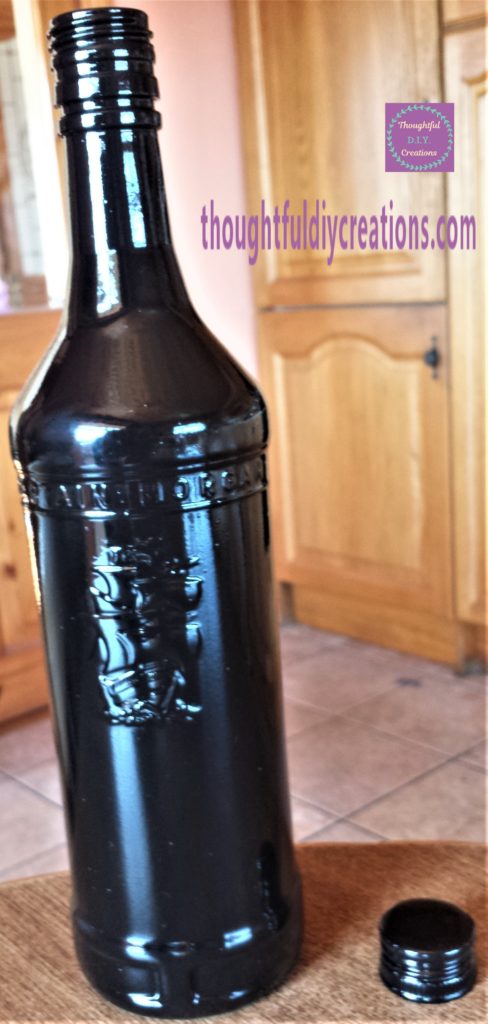 Front of the bottle after being brought back inside after spray paint was cured.