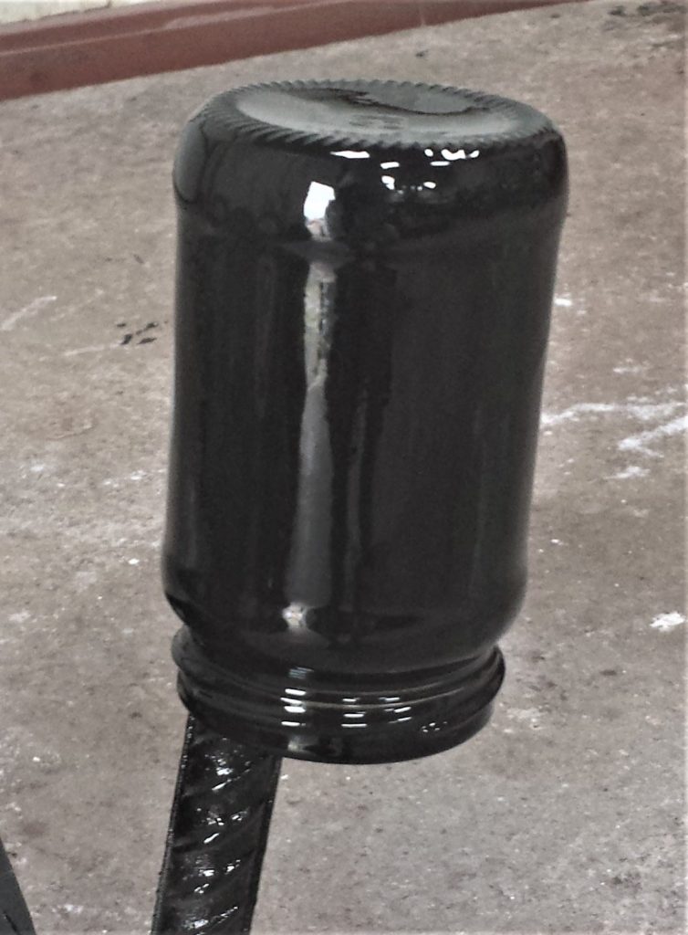 Second coat of spray paint on the jar.