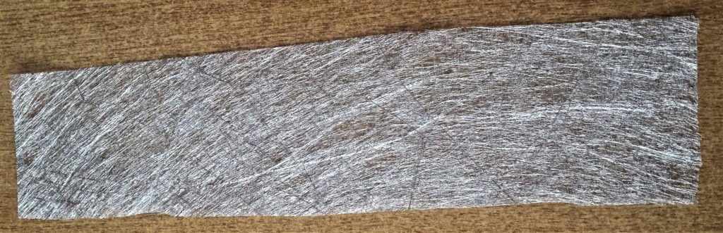 The silver fabric paper cut to fit the jar.