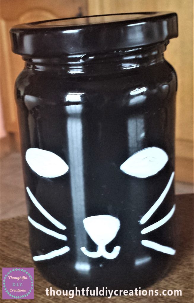 The cats eyes and nose filled in with white paint marker.