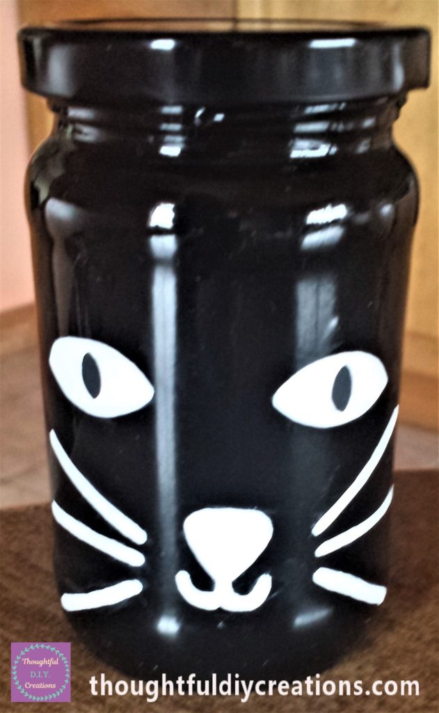 Black added to the cats eyes on the jar.